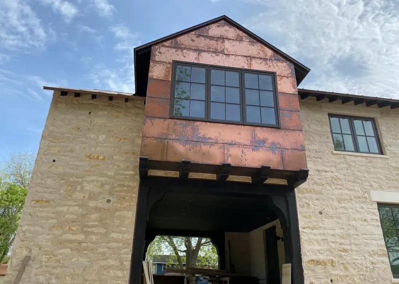 Copper metal panel facade on a stone building for Skylight Installation in Hyrum