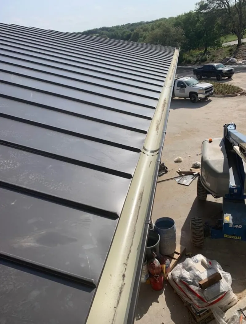 Standing seam panel and gutter detail on a metal roofing jobsite in Hyrum